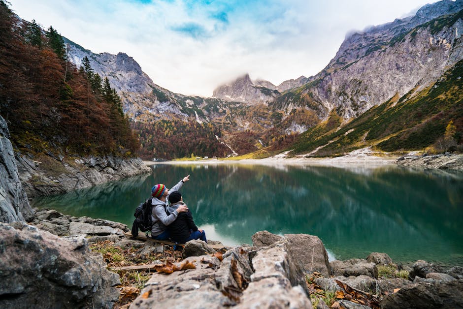 A couple enjoys a scenic view of Hallstatt Lake surrounded by mountains and fores